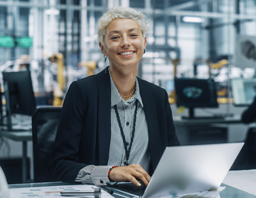 female worker in safety vest smiling at the camera